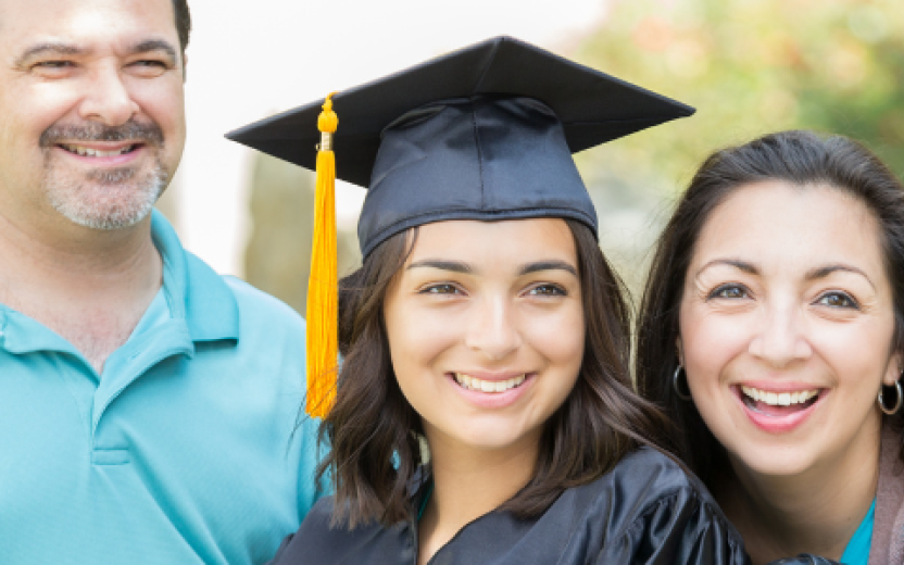 parents posing for photo with daughter in cap and gown