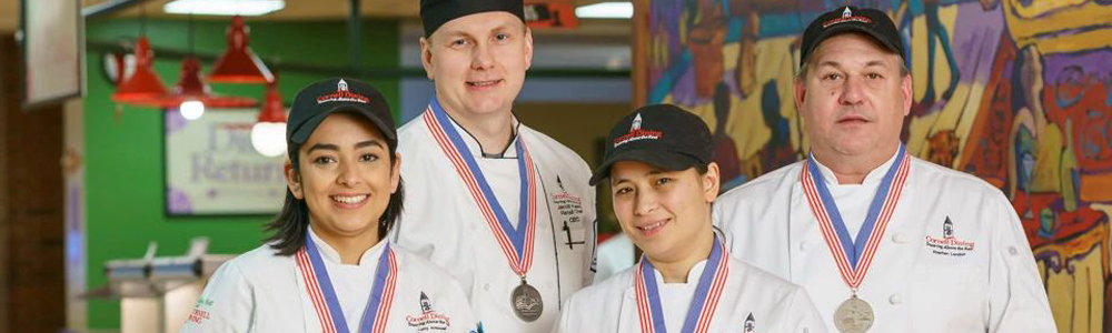 four award winning chefs at Cornell dining with medals