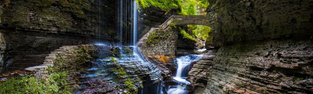 beautiful waterfall and bridge at Watkins Glen in NY Finger Lakes