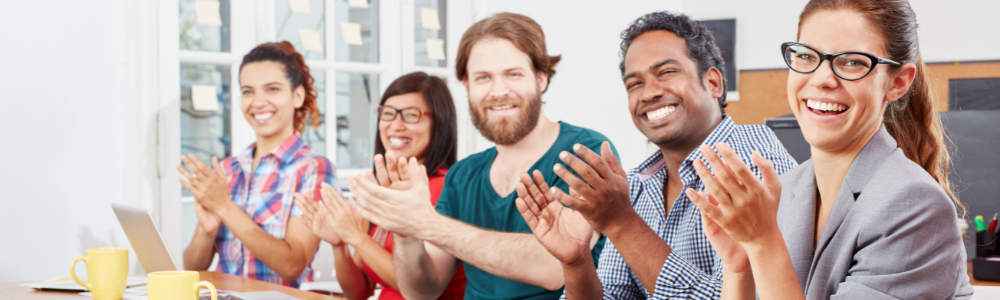 group of diverse people applauding in office