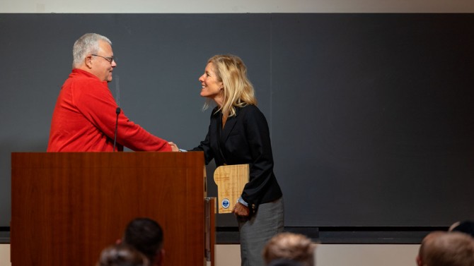 woman receiving award at podium