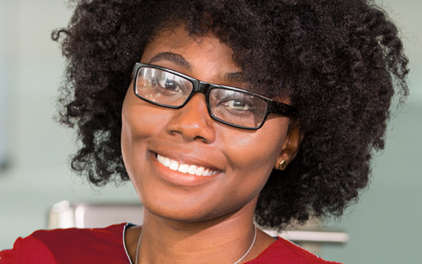 Black woman with glasses, smiling