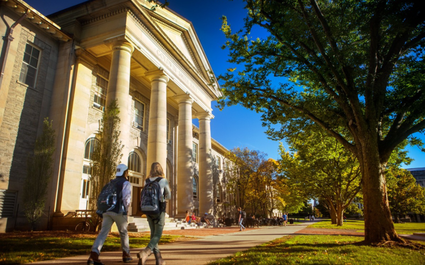 exterior view of Goldwin hall in summer with students walking