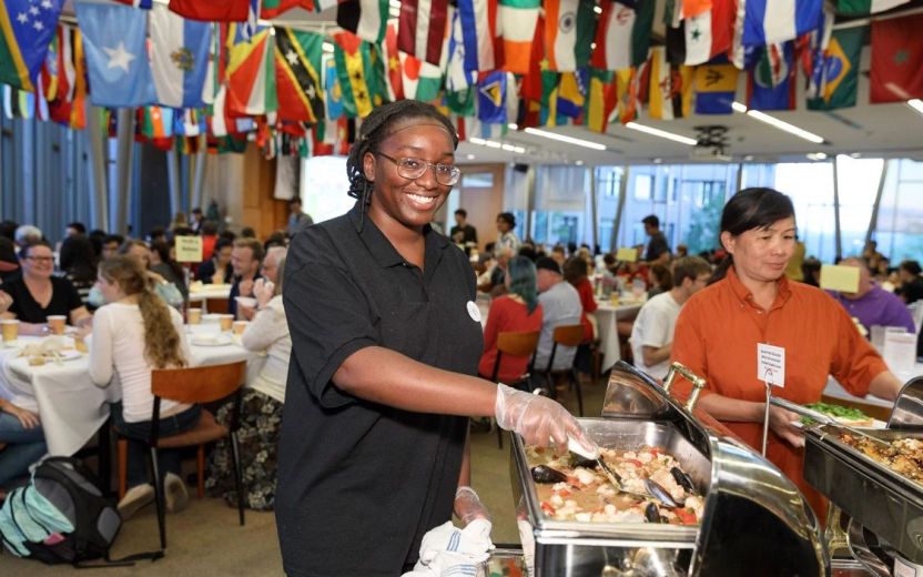 Cornell dining employee with international flags