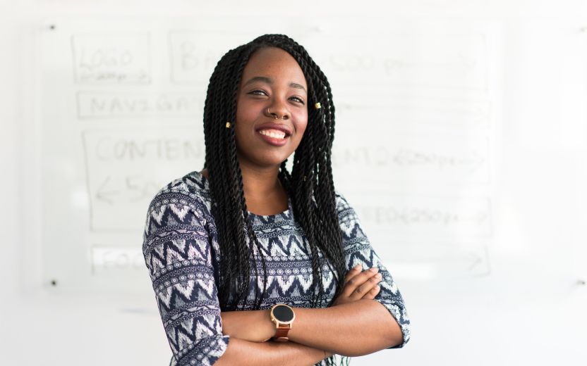 Black woman in front of white board with writing