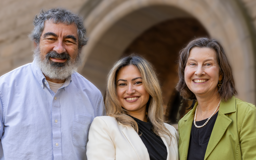 The three Cornell ombuds posed in front of old building