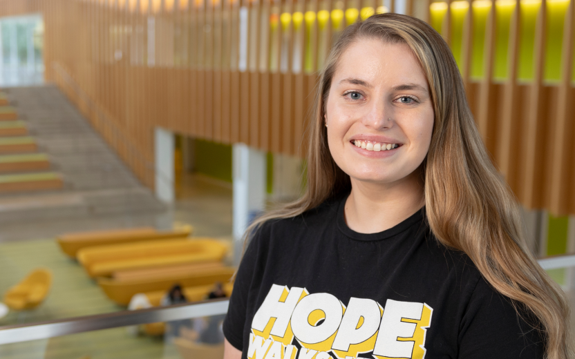 Cheyanne Scholl smiling, Schurmann hall atrium background