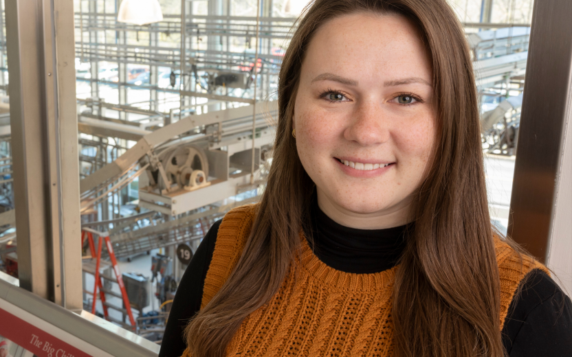 Maggie Jones smiling, Cornell dairy facility interior background