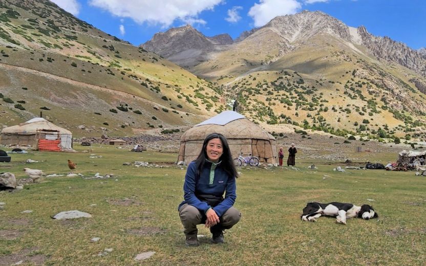 helen lee in front of yurts and mountains