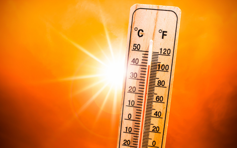 thermometer with 100 degree reading, blazing sun background