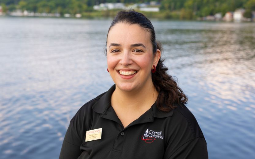 Marisa Ciotoli casual portrait in Cornell catering uniform with lake background