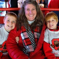 mom and kids in Cornell shirts at game