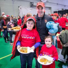 father and kids with plates of food