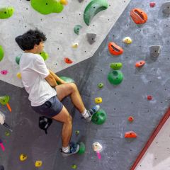 kid climbing on climbing wall