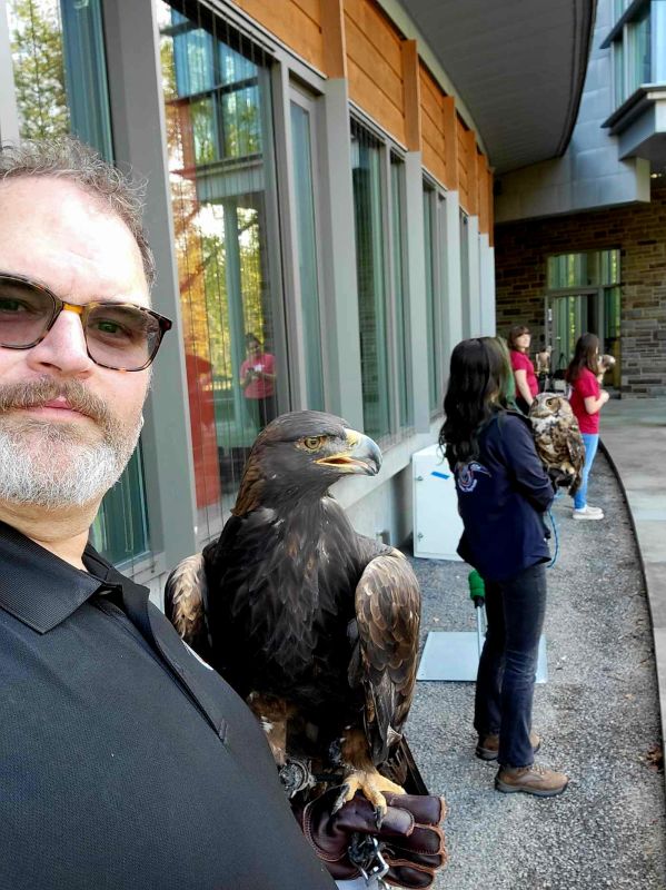 Woodg Horning holding a large bird of prey at an event