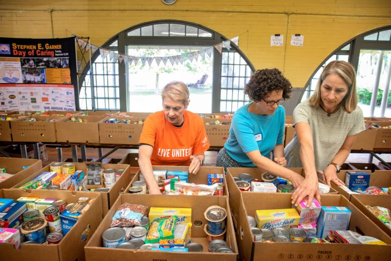 pat wynn, center with two other women, sorting boxes of food donations