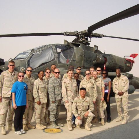 Jada Hamilton, fourth from left, with military unit in front of helicopter