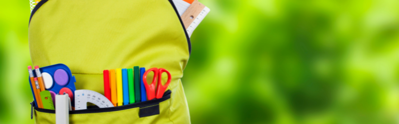 child's bright green backpack full of colorful supplies