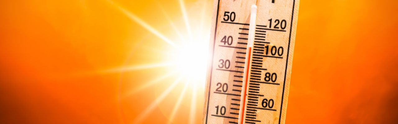thermometer with 100 degree reading, blazing sun background